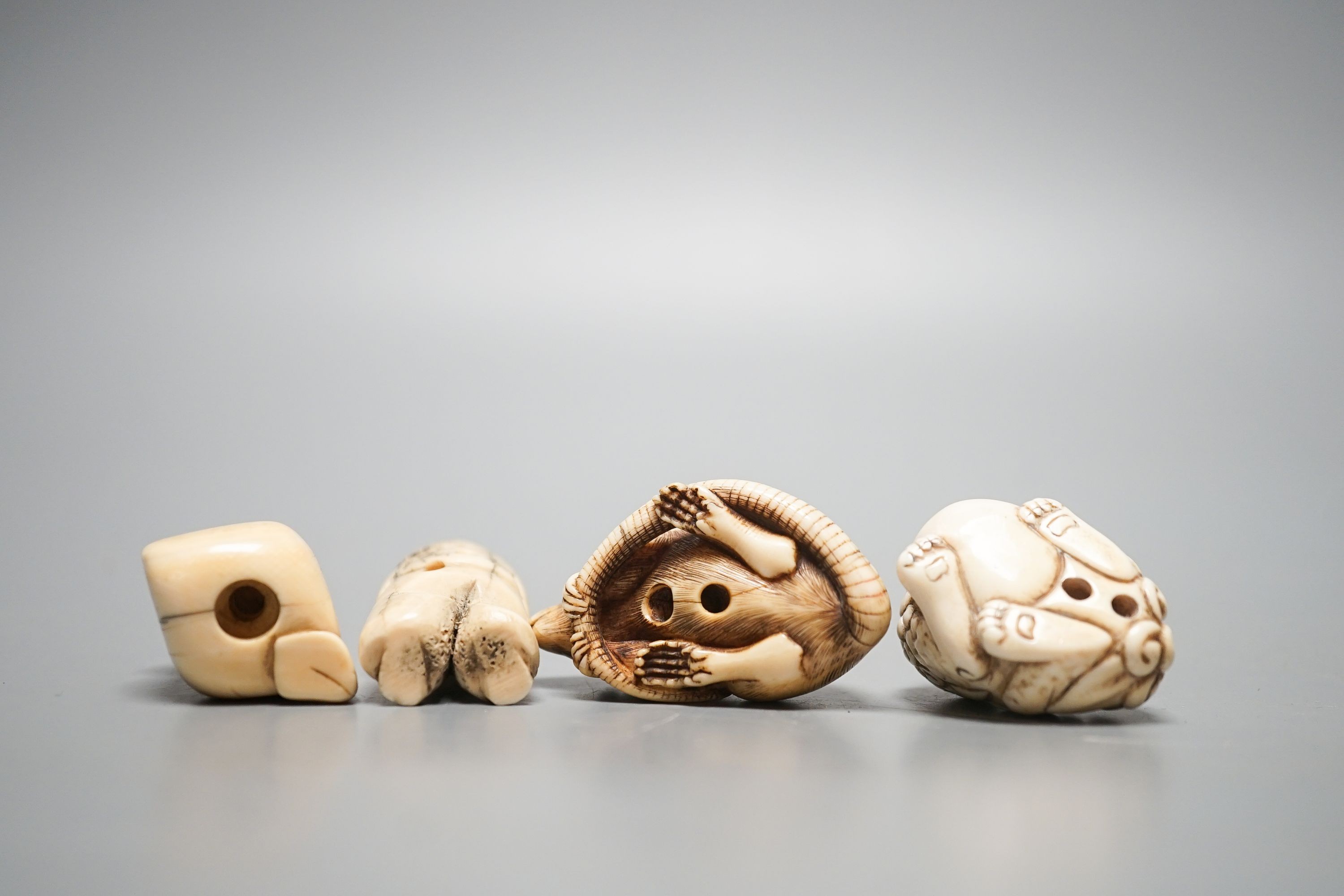 A 19th century ivory netsuke of a rat, horn inset eyes, 5.2cm, two other ivory netsuke and a stag horn netsuke (4)